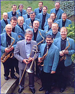 Jiggs Whigham and the BBC Big Band Jiggs Whigham and the BBC Big Band, viewed from above. Jiggs is wearing a suit and holding his trombone. The BBC Big Band are wearing pale blue jackets and dark shirts and holding their instruments.